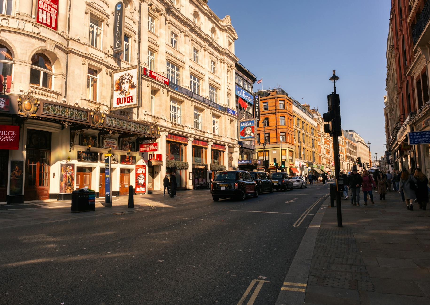 Capture of London's bustling West End theatre district bathed in warm daylight showcasing iconic landmarks.