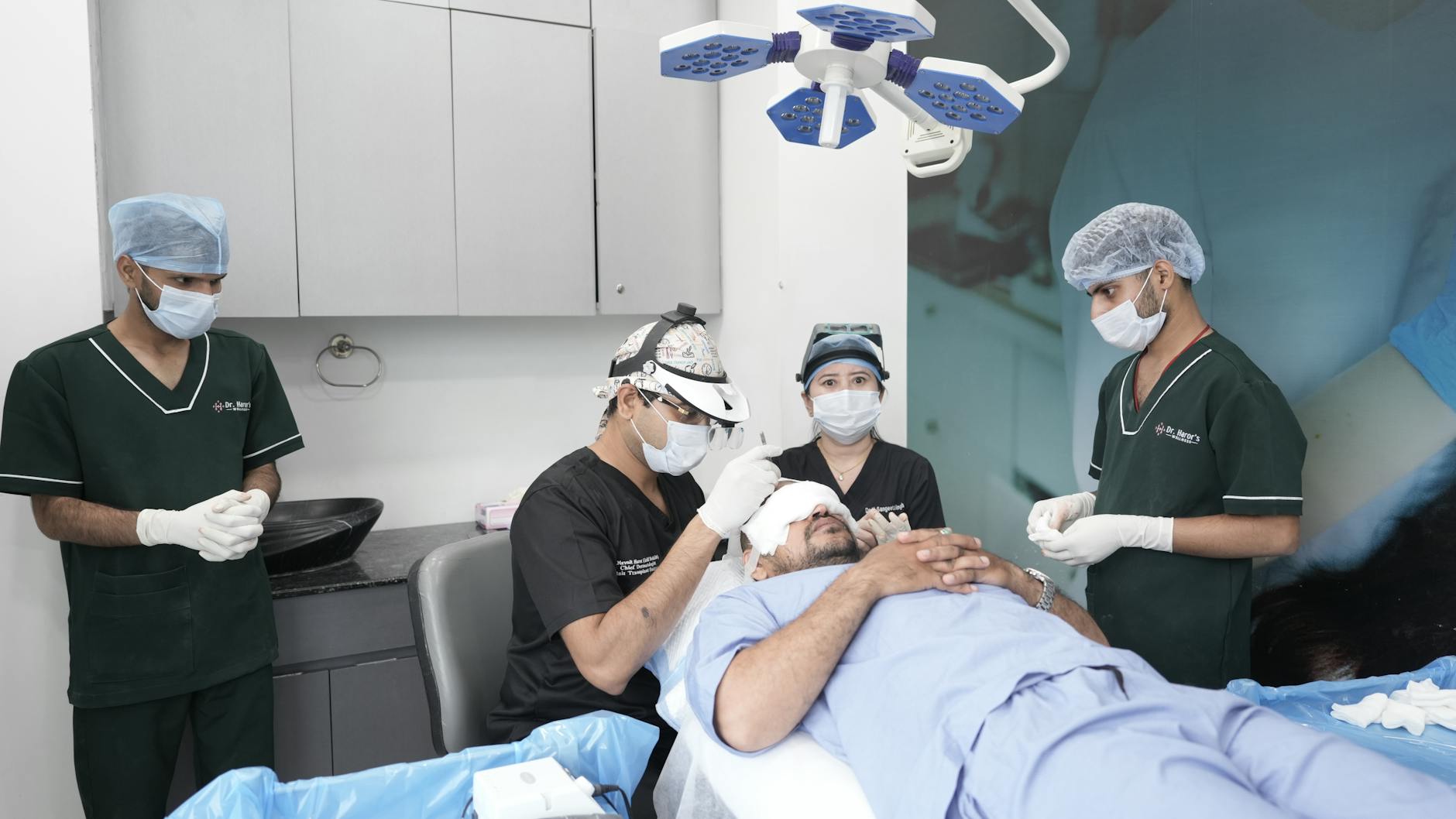 Medical professionals conducting a hair transplant in a clinic setting.