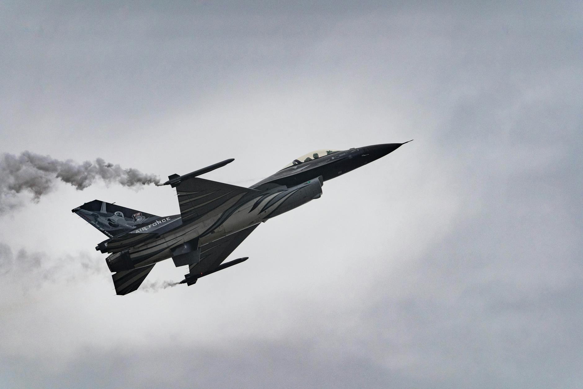 Captivating shot of an F-16 fighter jet soaring through the sky, displaying incredible precision.