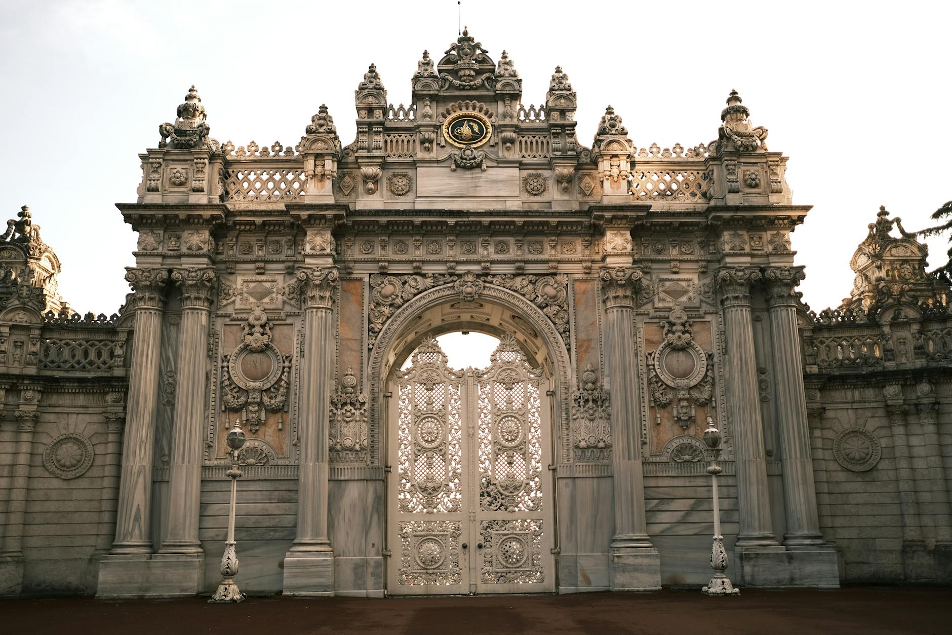 Ornate gate of Dolmabahçe Palace, Istanbul, showcasing intricate architectural details.