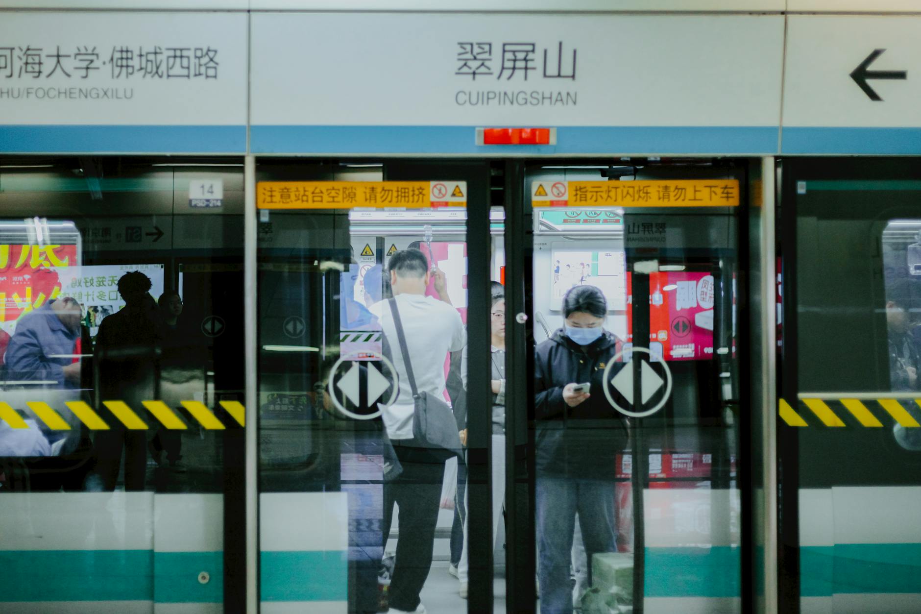 Commuters at Cuipingshan metro station in China, capturing urban life and public transport dynamics.